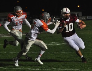 PRHS quarterback Gunnar Griffin runs past a Greyhound defender.