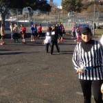 Co-race director Liz Byrnes watches the finishers come in.
