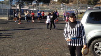 Co-race director Liz Byrnes watches the finishers come in.