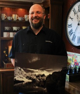 Jason Hickman holds his winning photo for the Pinnacles National Park photo contest. Photo by Heather Young