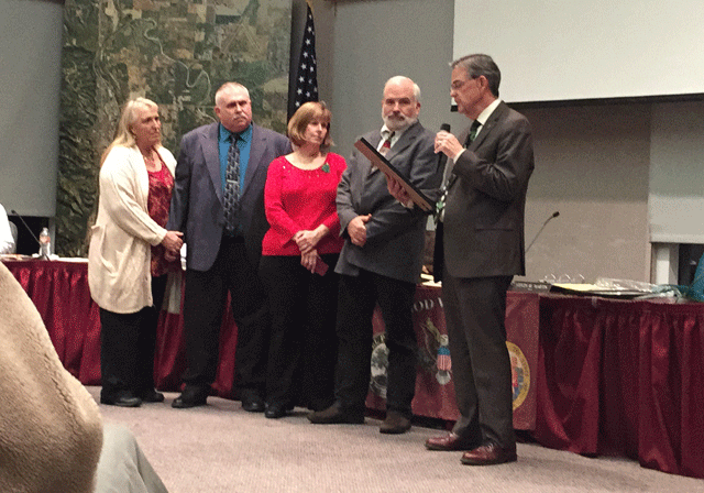 Mayor Steve Martin reads the proclamation for Ed Gallagher, second from right, who is retiring as the city's community development director. Photo by Heather Young