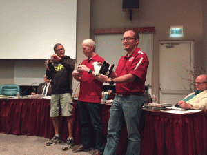 From left, girls cross country coach Ivan Huff, assistant coach Jory Hallanan and boys head coach Jon-Paul Ewing show off the medals they received from the Paso Robles City Council. Photo by Heather Young