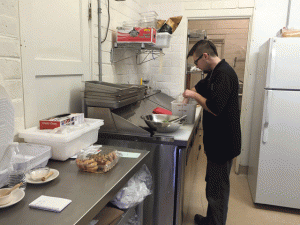 Next Door Bistro Chef Ed Drake prepares a salad in the kitchen. Photo by Heather Young
