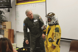 Freshman Erika Rendon tries some space food, peaches, through a tube designed especially to sustain pilots. Photo by Heather Young
