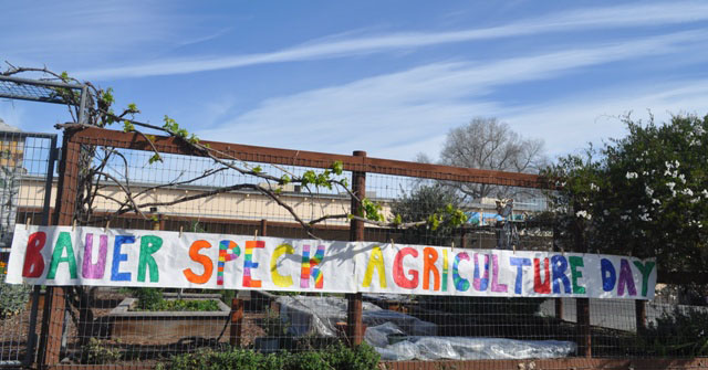 A banner hangs outside the Bauer-Speck Elementary School garden to celebrate Agriculture Day. Photo by Meagan Friberg