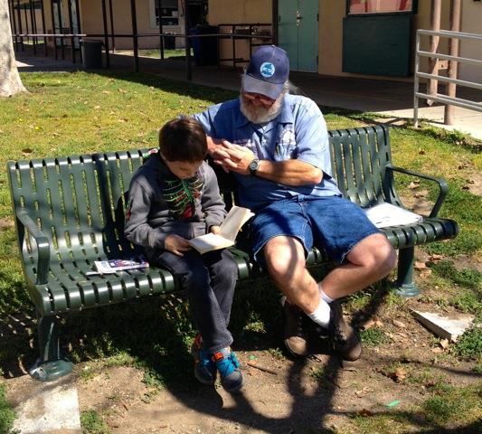 Don Simoneau reads with student Wyatt Moore.