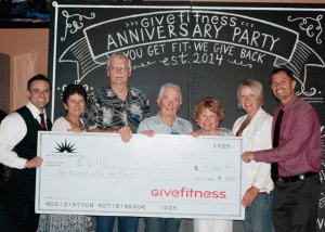 Give Fitness Health Club owners Josh Donovan, far left, and Matt Holguin, far right, present a check for $5,000 to the El Camino Homeless Organization.