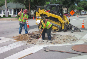 The contractor is currently lowering all the utility covers in preparation of the paving work.