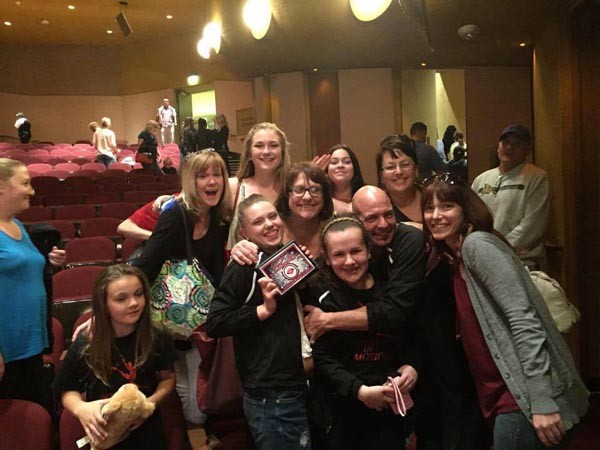 Bob Woodard hugs his team of winning dancers at the Fresno competition. Photo courtesy Bob Woodard.
