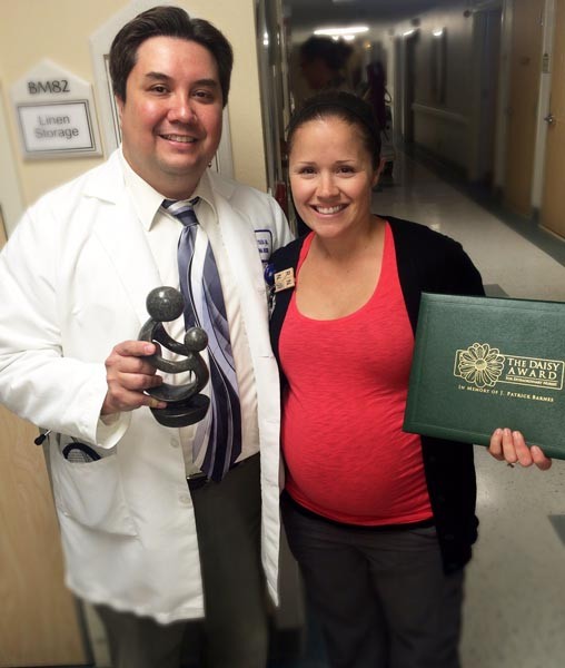 Twin Cities Community Hospital DAISY Award recipient Summer Garcia, (right), accepts the honor for “Extraordinary” skills and care with Sergio Toledo, MD, Twin Cities hospitalist (left) before her fellow nurses and Twin Cities Community Hospital staff.