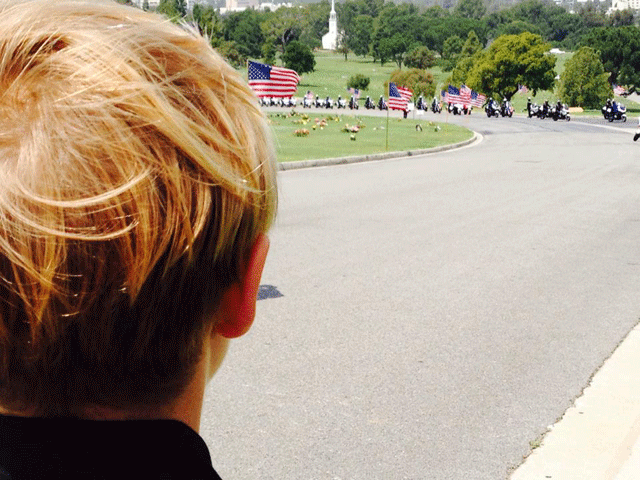 Cooper Wommack watches as the motorcade approaches at his uncle, Chris Cortijo's service. Photo courtesy of Kyle Beal Wommack