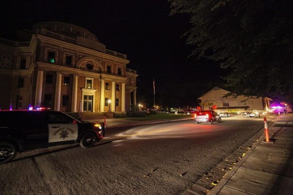 The nearly 100-year-old log cabin moves through the streets of Atascadero last Monday. Photo by Rick Evans