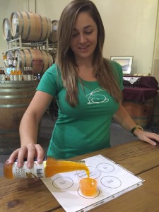 Sarah Fleming pours a sample of her Paso Pure orange cream craft soda. Photo by Paula McCambridge
