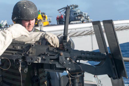 Aviation Ordnanceman Airman Amber Deranek, from Paso Robles, Calif., reloads a .50 cal machine gun during a live-fire exercise aboard USS John C. Stennis (CVN 74).