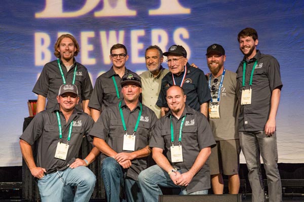 Photo by John Holzer. Back row, left to right: Patrick Hayes, brewer, Atascadero ; Robert Emery, sensory analyst lab technician, Atascadero; Charlie Papazian of the Brewers Association; Grandpa Brynildson, Minnesota; Matt Brynildson, brewmaster, Paso Robles; Tim Miller, brewer, SLO. Bottom row, left to right: Ryan Hamill, Brewer, Grover Beach; Dustin Kral, head brewer, SLO; Jason Pond, cellar manager, Atascadero.
