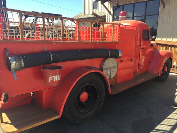 The real, antique fire engine and custom-made club house were designed and built by local treehouse builders, Daniel’s Wood Land.