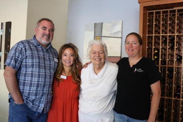 Mark McConnell (Broker/Owner), Liz Lee (Broker/Owner), Pearl Munak (Founder of Transitional Food and Shelter), Heather Mikelonis (Board of Directors of Transitional Food & Shelter)