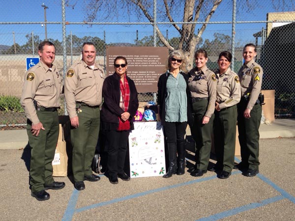 Pictured from l to r: Undersheriff Tim Olivas, Correctional Captain George Clarkson, Rita's Rainbows volunteer Pat Hamilton, Rita's Rainbows founder Cassandra Goehner, Correctional Lt. Denise Armstrong, Correctional Lt. Kelly Kenitz and Correctional Sgt. Stephanie Landgraf