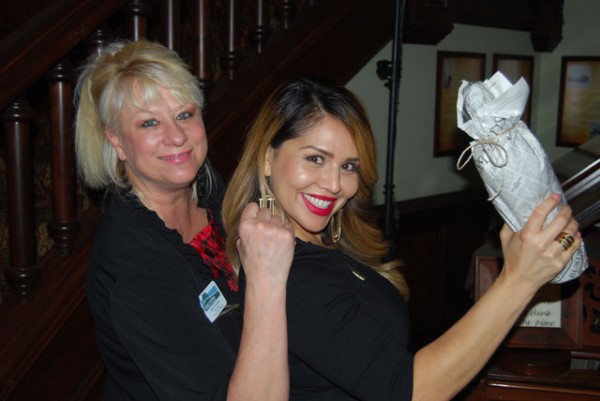 Paso Robles Chamber volunteers Hope Cornejo, left, and Valerie Gonzales sell bottles of wine to attendees.