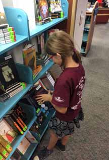 Student browses new collection of Battle of the Books titles.