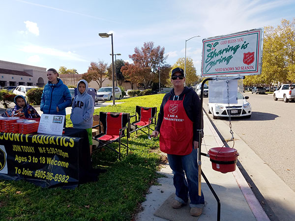 Paso Robles volunteers with North County Aquatics and the Salvation Army on the sidewalk on 6th St.