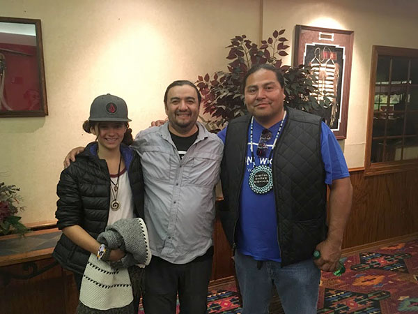 Middle-schooler Liliana Monge with her father Roberto and Myron Dewey, founder of Digital Smoke Signals.
