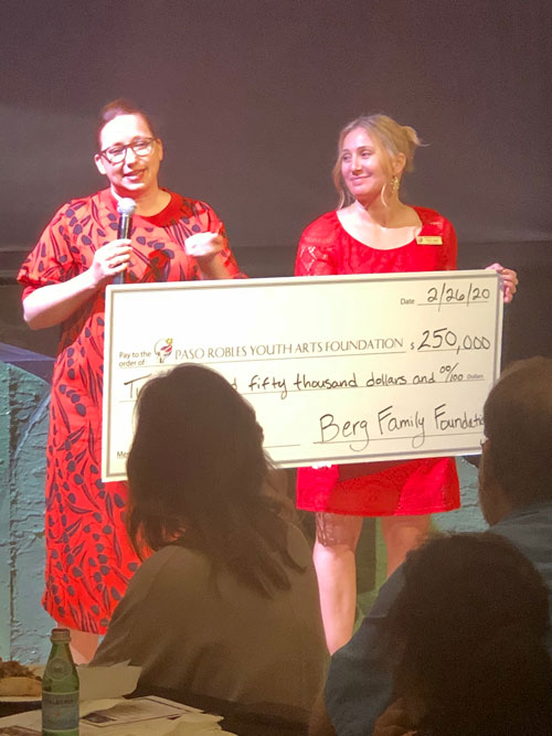 PRYAF Executive Director Emily Jagger, right, receives a check for $250,000 from Jennifer Lahoda, left, Donna Berg's granddaughter who made the gift on behalf of the Berg Family Foundation. I