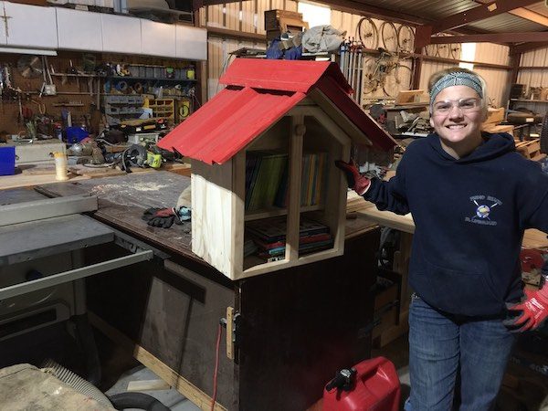 Hannah Bourgault completes a tiny library for elementary students