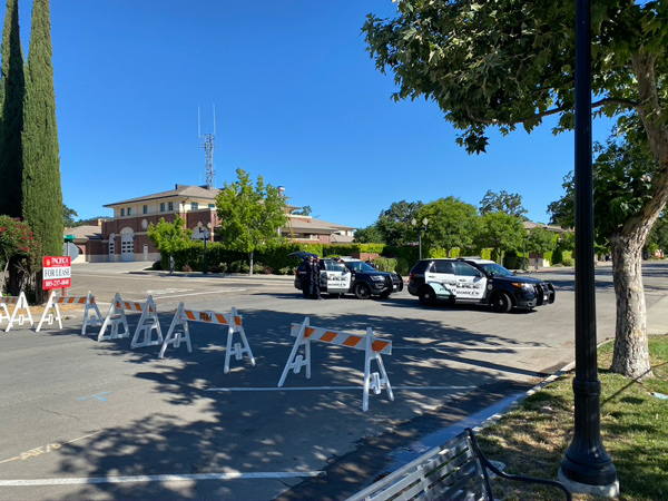 Law enforcement maintains a barricade at the corner of 9th and Pine streets Wednesday at 9 a.m.