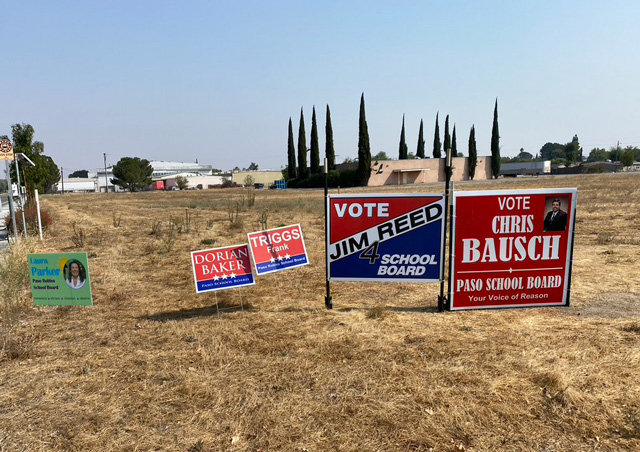 Campaign signs for school board candidates Laura Parker, Dorian Baker, Frank Triggs, Jim Reed, and Chris Bauch