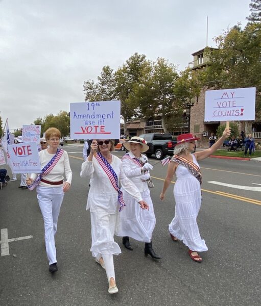 Women dressed in white portrayed suffragists on the 100th anniversary of women getting the right to vote.