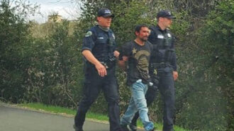 Police escort a robbery suspect near the Salinas Riverbed on Friday afternoon. Photo by Brandon Stier.