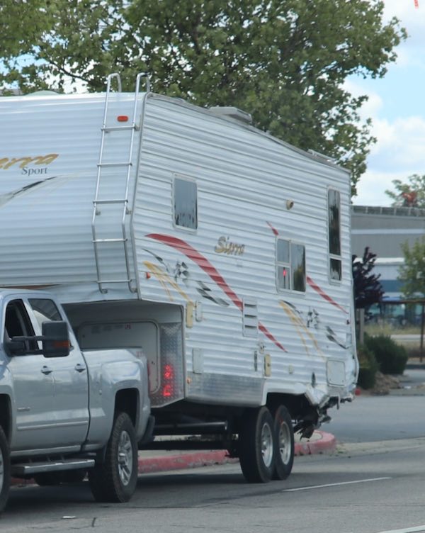 Driver uninjured after collision with travel trailer