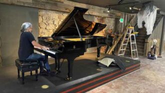 Corey at large piano playing