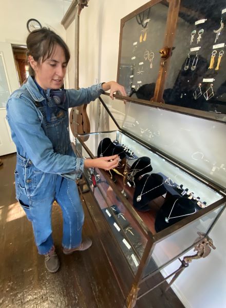 Chloe examines her Jewelry