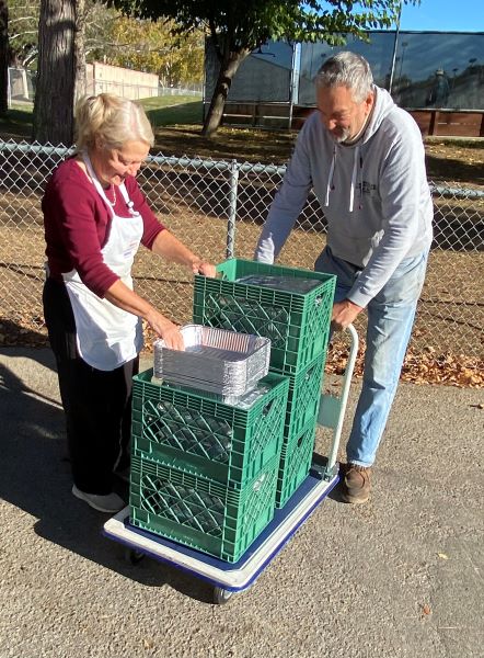 David Kudija and Lissa Olbeter unload string beans