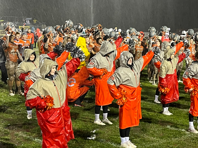 Cheerleaders bring energy to lead their alma mater to victory.