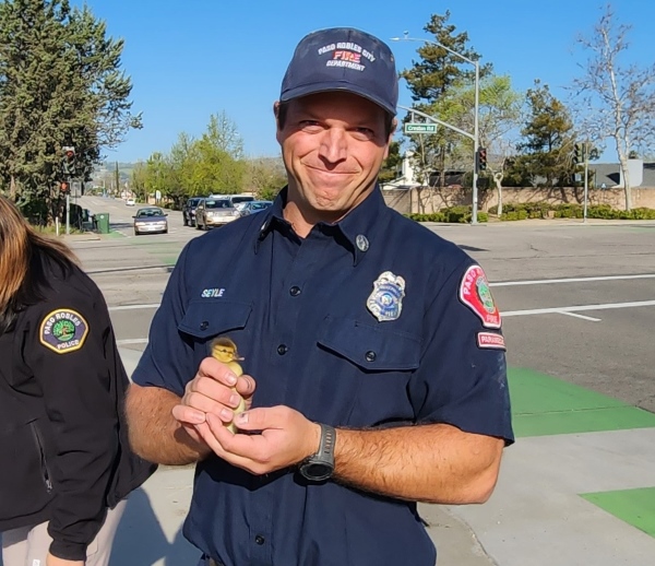 firefighter with duckling