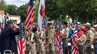 Cal Poly Color Guard enter Faces of Freedom Plaza