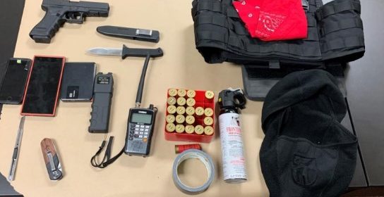 Police search finds weapons, stab-resistant vest, police scanner