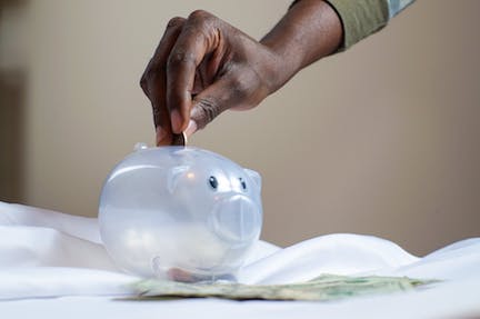 https://www.pexels.com/photo/person-putting-coin-in-a-piggy-bank-3833052/