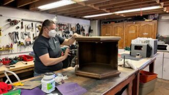 Photo caption: Stephanie Wright, Habitat SLO ReStores Manager, sands a side table at the Paso Robles ReStore.