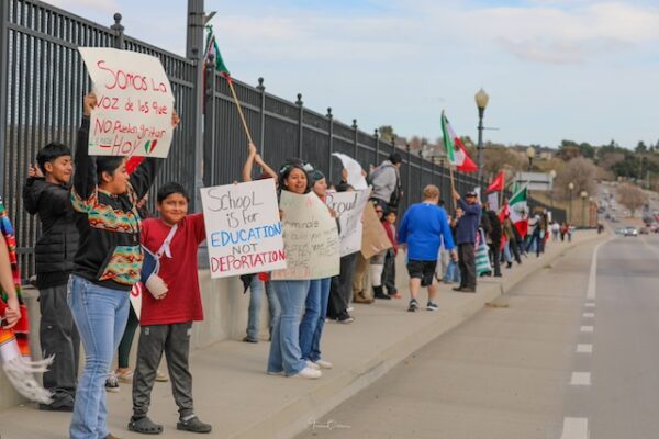 Community members gather at busy intersection to voice opposition