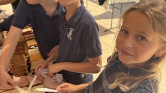 Logan Schwartz and Hadley Hoover prepare sandwiches for Echo Homeless Shelter