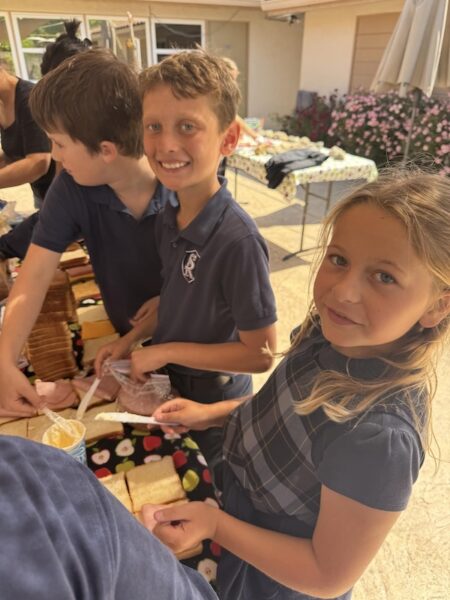 Logan Schwartz and Hadley Hoover prepare sandwiches for Echo Homeless Shelter