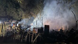 Fire destroys barn and spreads into vegetation near Creston